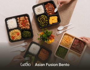 Asian fusion bento boxes laid out for a corporate lunch, including a premium wooden wagyu box. Cuseho Asian fusion bento catering, Singapore