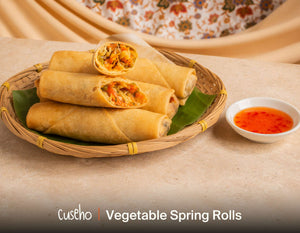 Crispy vegetable spring rolls with sweet chilli dip in a bamboo basket. Cuseho Asian fusion mini buffet catering, Singapore