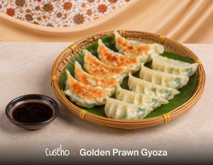 Pan-fried golden prawn gyoza in a bamboo basket with ginger soy dip. Cuseho Chinese fusion mini buffet catering, Singapore