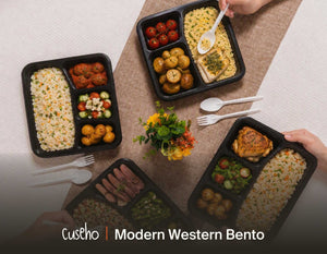 Four Modern Western bento boxes laid out for a corporate lunch, each with grain, protein, salad and side compartments. Cuseho Modern Western bento catering, Singapore